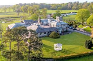 an aerial view of a large house on a green field at Hundith Hill Hotel in Cockermouth