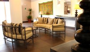 a living room with chairs and a couch and a table at Hotel O'scià in Lampedusa