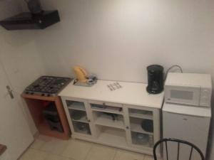 a small kitchen with a stove and a microwave at jolie appartement centre de Fismes in Fismes
