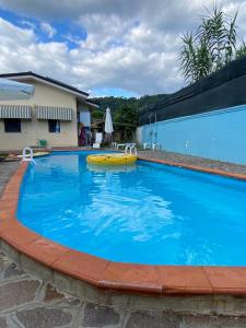 a large blue swimming pool with a yellow object in it at Villa La Perla in Corsanico-Bargecchia