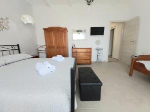 ein Schlafzimmer mit einem Bett mit zwei Handtüchern darauf in der Unterkunft Amononna in Ragusa