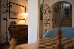 a room with a table and a lamp and a stairway at Hotel Danila in Portoferraio