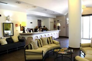 a lobby with couches and a bar at Hotel O'scià in Lampedusa