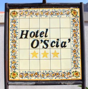 a sign for a hotel oasis at Hotel O'scià in Lampedusa