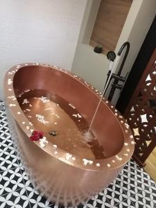 a copper bath tub with a stream of water at Hotel Boutique Rayón 50 in Morelia