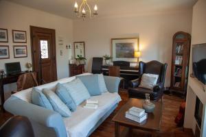 a living room with a couch and a table at Lorantina Luxury Sea View House with Starlink WiFi near Barbati & Ipsos in Spartýlas
