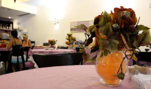 a vase filled with flowers sitting on top of a table at Hotel O'scià in Lampedusa