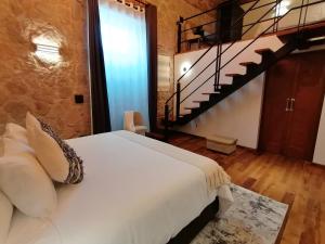 a bedroom with a bed and a staircase at Hotel Boutique Rayón 50 in Morelia