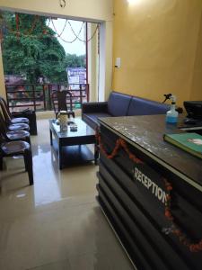 a living room with a couch and a table at HOTEL AWADH KAILASH in Bahraich