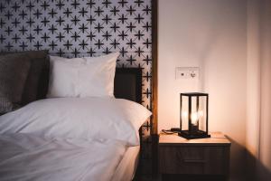 a bedroom with a bed and a night stand with a lamp at Mathias Rex in Szentendre