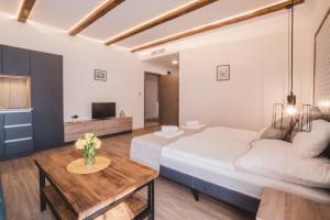 a bedroom with a large bed and a table at Mathias Rex in Szentendre