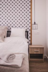 a bedroom with a white bed and a table at Mathias Rex in Szentendre