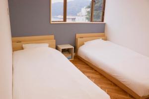 Krevet ili kreveti u jedinici u okviru objekta Guesthouse All you need - All rooms have an ocean view!