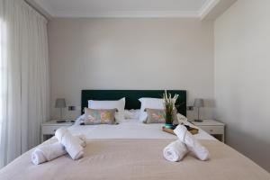 a bedroom with a large white bed with two pillows at Amarre Moon in Puerto de Mogán
