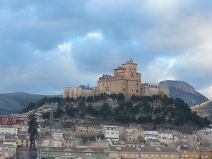 a castle on top of a hill with buildings at Apartamentos Aixa II in Caravaca de la Cruz