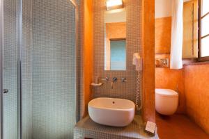a bathroom with a shower with a sink and a toilet at Hotel Le Capanne in Arezzo