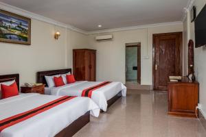 Postel nebo postele na pokoji v ubytování Angkor Mithona Guesthouse