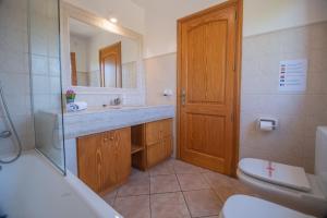 a bathroom with a sink and a toilet and a mirror at G324 Vela 1 by Mallorca Villa Selection in Muro +36 photos