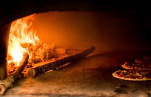 a pizza oven with two pizzas in it at Vecchio Mulino in Castel del Giudice