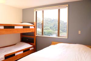Krevet ili kreveti u jedinici u okviru objekta Guesthouse All you need - All rooms have an ocean view!