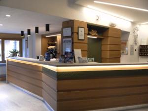 a bar in a restaurant with a counter at Hotel Tripoli La Margherita in Limone Piemonte +19 photos