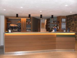 a bar with a wooden counter in a room at Hotel Tripoli La Margherita in Limone Piemonte