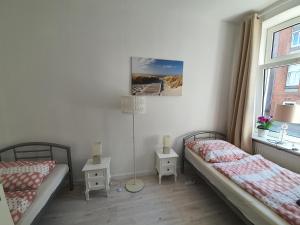 Ein Bett oder Betten in einem Zimmer der Unterkunft Husum Zentrum bis 5 Personen