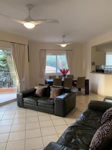 ein Wohnzimmer mit einem Sofa und einem Esszimmer in der Unterkunft Limnaria Gardens: Sunny 2 Bed Apartment in Paphos City
