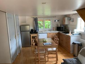 een kleine keuken met een tafel en een koelkast bij Manoir de la Vente de Rouville in Mesnil-Raoul