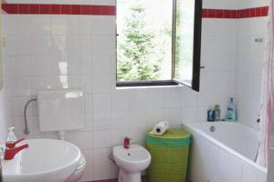 a bathroom with a toilet and a sink and a tub at MURIN DELFIN in Umag +28 photos