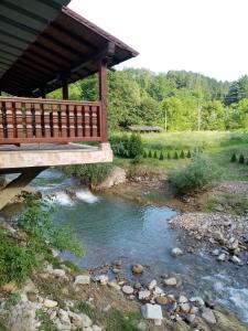 a wooden bridge over a stream with a river at Guesthouse Smiljanić in Slavkovica