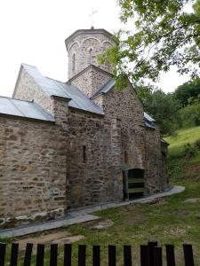 an old stone building with a tower on top of it at Guesthouse Smiljanić in Slavkovica