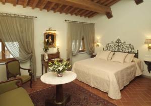 a bedroom with a bed and a table and a chair at Villa Olmi Firenze in Florence