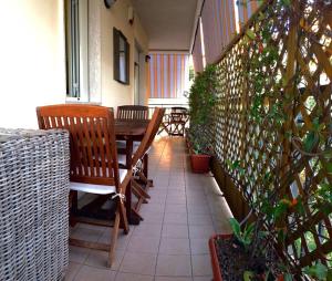 a balcony with a wooden table and chairs and plants at Madreperla - Gaeta in Gaeta