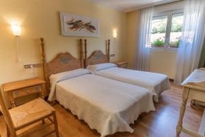 Postel nebo postele na pokoji v ubytování Hotel Río Cea