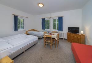 Postel nebo postele na pokoji v ubytování Hotel Tři Růže