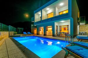 a villa with a swimming pool at night at Villa The Secret Diamond in Pag