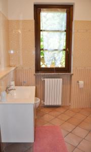 baño con lavabo y ventana en B&B Sarita's Rooms, en Certosa di Pavia