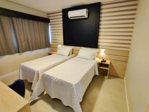 Postel nebo postele na pokoji v ubytování Mogano Express Hotel- ELETROPOSTO
