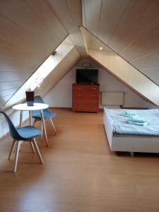 1 dormitorio con 1 cama, 1 mesa y 1 silla en Willa IDYLLA, en Kołobrzeg