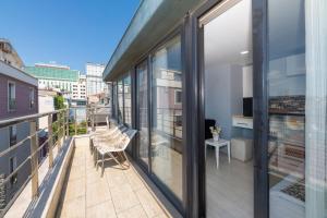 a balcony with glass doors and a chair on a building at Taksim Peri Suite in Istanbul