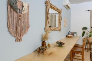 a room with a table and a mirror on the wall at Jordan Valley Birding Lodge in Kefar Ruppin