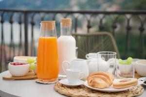 a table with bread and bottles of milk and orange juice at Calamarina B&B in Vietri sul Mare