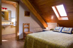 1 dormitorio con 1 cama y baño con lavamanos en Casa rural Lucuj, en Jaurrieta