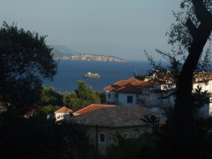 a view of the ocean from a town with houses at Magda's Hotel Apartments in Parga