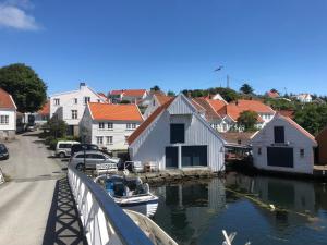 a town with a marina with boats in the water at Apartment Old Town Skudeneshavn in Skudeneshavn