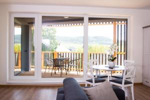 a living room with a large sliding glass door at Apartmány ADH Dolní Morava in Dolní Morava