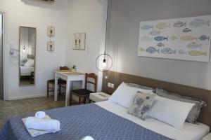 a bedroom with a bed and a table with a chair at House Fedra in Potos