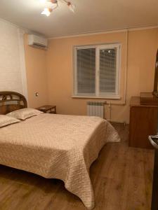 a bedroom with a bed and a window at 139А Проспект Добровольского Уютная Трех Комнатная квартира в Одессе in Odesa