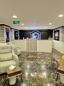 a lobby with couches and a bar in a building at فندق الحاتمية in Abha